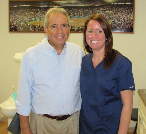 Dr. Shannon Rodrigues Espinola Dentist and her husband standing together at Rodrigues Dental Group in Fall River, MA